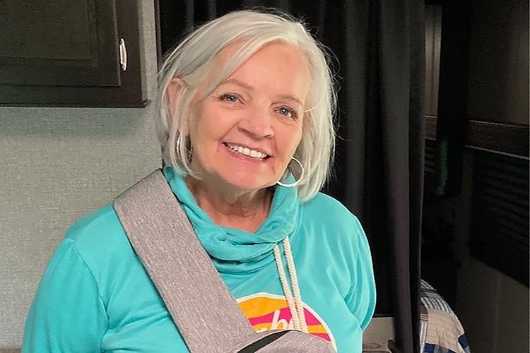 Trina Titus standing in her camper.