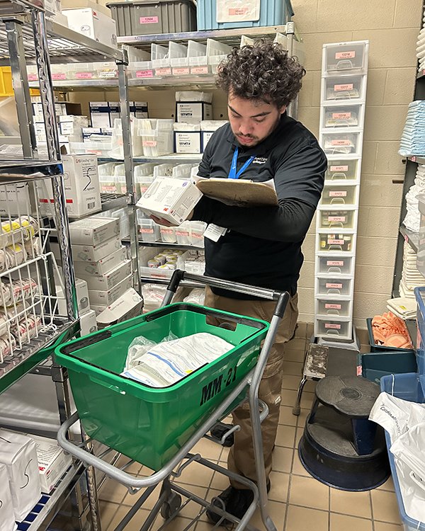 Photo of Project Search intern getting deliveries ready.