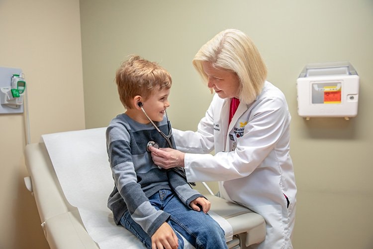 Photo of Dr. Hill with pediatric patient.