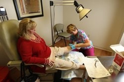 A nurse dressing a wound