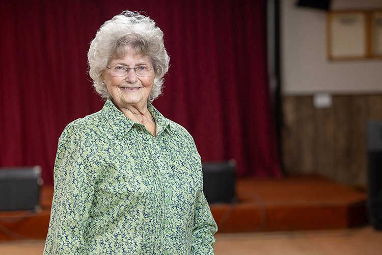 Photo of Kathy Filcek smiling and dancing.