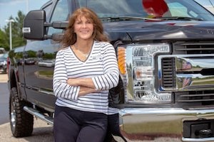 Photo of Karyn Randall, Outpatient Knee Replacement Patient standing in front of pick up truck.