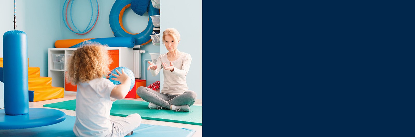 Photo a young girl working with with a Physical Therapist on hand-eye coordination.