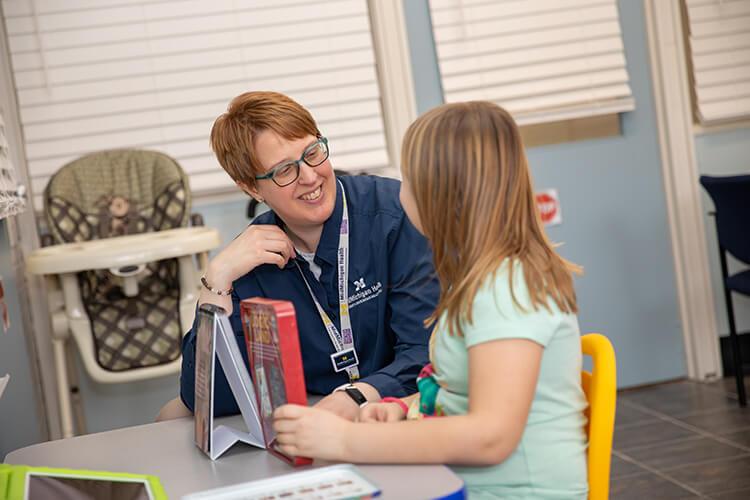 Photo of a therapist with a young girl at the Pediatric Center in Midland, Michigan.