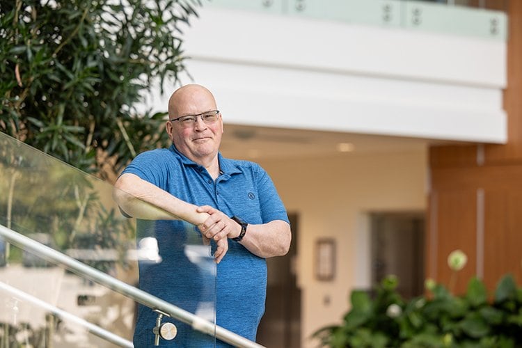 Photo of Mike Fowler standing on steps at MyMichigan Medical Center Midland.