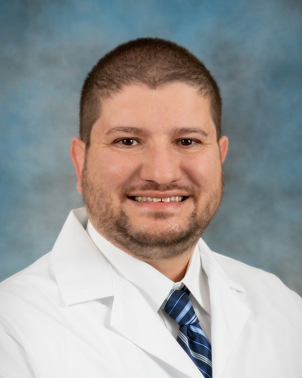 Photo of Dr. Elgamal wearing a white lab coat.