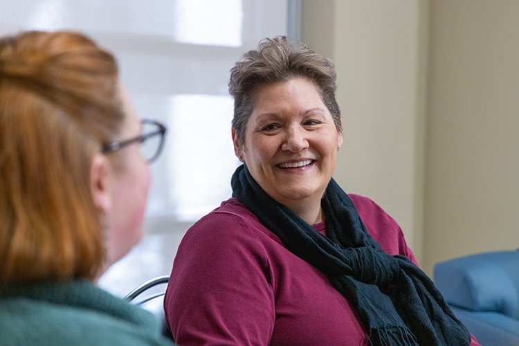 Photo of Jules Brown talking with Partial Hospitalization Program staff.