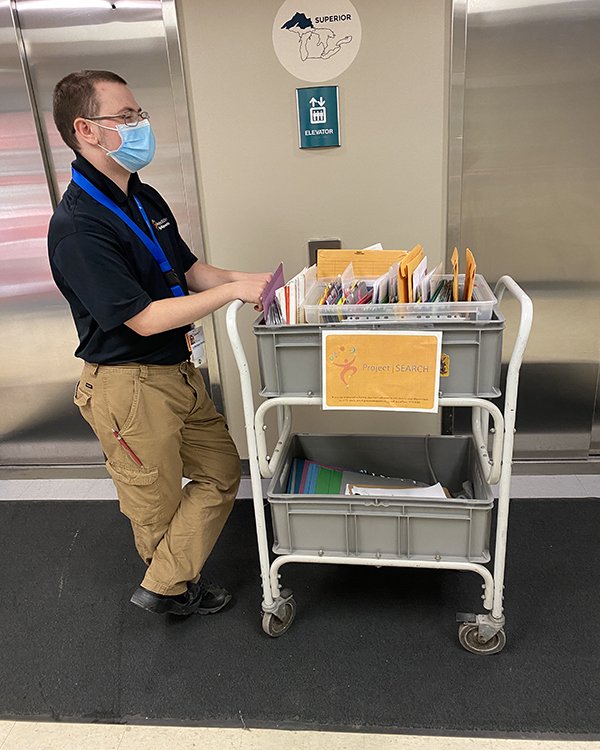 Photo of Project Search intern delivering mail.