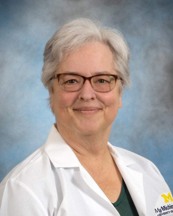 Professional headshot of Dr. Musil wearing white lab coat.