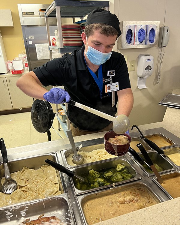 Photo of Project SEARCH intern serving food