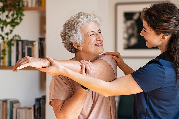 Photo of an older women doing physical therapy.