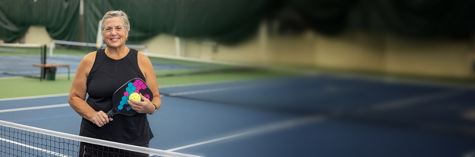 Photo of Kendall Morris standing at the pickleball court.