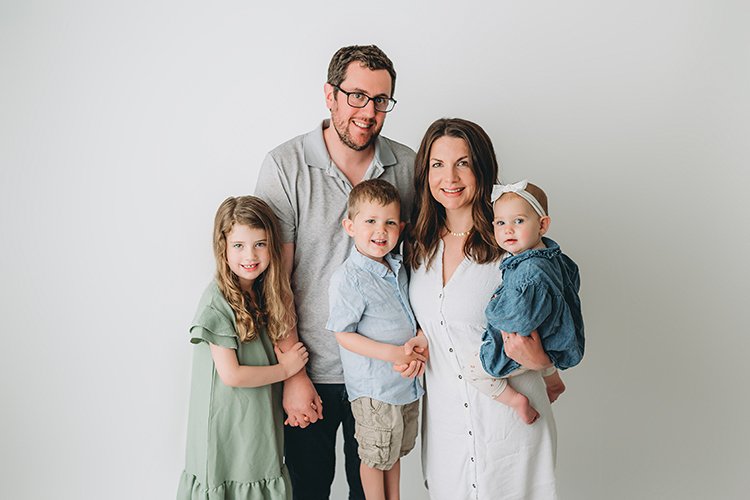 A photo of the Rubinstein Family, mom, dad, and three small children.