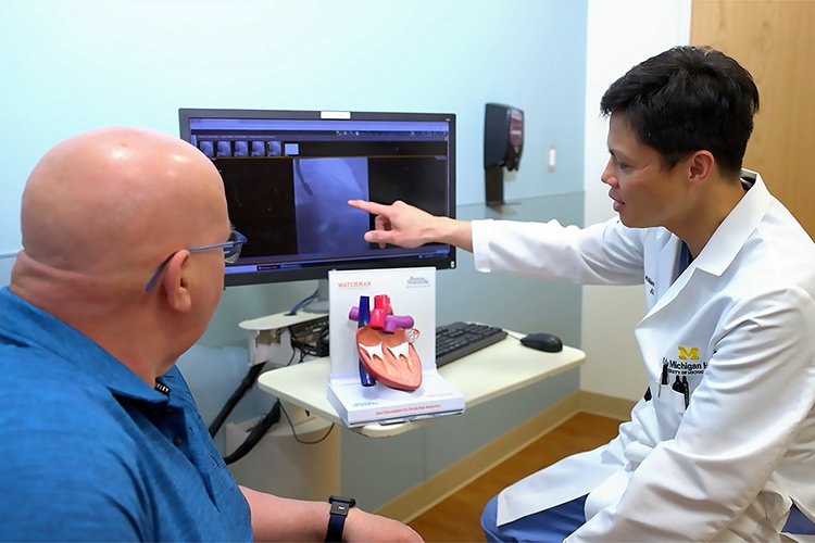 Photo of Dr. Mellana explaining and showing Michael Fowler the WATCHMAN procedure.